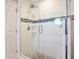 This walk-in shower features glass doors, modern tiling, and pebble flooring at 2300 Avenue B, Bradenton Beach, FL 34217