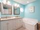 Bright bathroom features double vanity, tub, and ample storage space for added convenience at 2300 Avenue B, Bradenton Beach, FL 34217