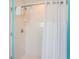 Clean and well-maintained shower with a shower curtain and neutral tile work at 2300 Avenue B, Bradenton Beach, FL 34217