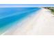 Stunning aerial shot of a serene beach with gentle waves and clear blue water at 2300 Avenue B, Bradenton Beach, FL 34217