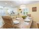 Dining room with white chairs and a wood table, with a partial view of the kitchen at 2300 Avenue B, Bradenton Beach, FL 34217