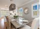 Open dining room with decorative chandelier, seating for six and kitchen views at 2300 Avenue B, Bradenton Beach, FL 34217