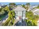 Beautiful two-story home with a brick driveway, palm trees and a view of the ocean at 2300 Avenue B, Bradenton Beach, FL 34217