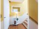 Inviting yellow hallway features wood floors, stairs and a mirror on the wall at 2300 Avenue B, Bradenton Beach, FL 34217