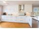 Beautiful, modern kitchen with white cabinets, stainless steel appliances, and hardwood floors at 2300 Avenue B, Bradenton Beach, FL 34217