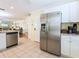 Spacious kitchen with stainless steel appliances, granite countertops, and tile flooring adjacent to living area at 2300 Avenue B, Bradenton Beach, FL 34217