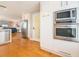 Updated kitchen features stainless steel appliances, white cabinets, and hardwood floors at 2300 Avenue B, Bradenton Beach, FL 34217