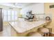 Bright eat-in kitchen features a breakfast bar with granite countertops, white cabinets, and stainless appliances at 2300 Avenue B, Bradenton Beach, FL 34217
