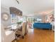 Open concept living room with dining area featuring hardwood floors and bright coastal decor at 2300 Avenue B, Bradenton Beach, FL 34217