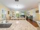 Open-concept living space features a dining table and living room with access to the balcony at 2300 Avenue B, Bradenton Beach, FL 34217