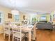 Spacious open floor plan with dining table, living room, and sliding glass doors to the balcony at 2300 Avenue B, Bradenton Beach, FL 34217