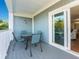 Covered outdoor patio with dining table and chairs and sliding glass door into living area at 2300 Avenue B, Bradenton Beach, FL 34217