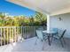 Covered outdoor patio with dining table and chairs overlooking lush tropical landscaping at 2300 Avenue B, Bradenton Beach, FL 34217