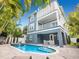 Exterior shot of a private pool and spa with a two-story home featuring a patio area at 2300 Avenue B, Bradenton Beach, FL 34217