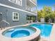 Backyard features a pool and spa with stone surround near a covered patio and lush landscaping at 2300 Avenue B, Bradenton Beach, FL 34217