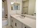 Modern bathroom vanity features sleek hardware, gray tile and shower with a dark faucet and showerhead at 2616 Star Apple Way, Sarasota, FL 34240
