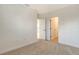 Spacious bedroom with neutral walls, carpet flooring, and a doorway to an adjacent room at 2616 Star Apple Way, Sarasota, FL 34240