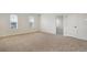 Spacious bedroom with neutral carpet and two windows for natural light at 2616 Star Apple Way, Sarasota, FL 34240