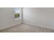 Cozy bedroom with neutral walls, carpeted floor, and a bright window view at 2616 Star Apple Way, Sarasota, FL 34240