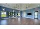Spacious yoga studio featuring wood-look floors, bright blue walls, ceiling fans, and a wall of mirrors at 2616 Star Apple Way, Sarasota, FL 34240
