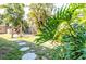 Secluded backyard showcasing vibrant tropical plants, a wooden fence, and inviting outdoor seating at 2830 Gypsy St, Sarasota, FL 34231