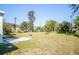 Lush backyard with manicured lawn and tropical landscaping offering privacy and outdoor enjoyment at 2830 Gypsy St, Sarasota, FL 34231