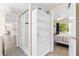 Bright bathroom leads to bedroom and features tile flooring, standing shelf, and shower at 2830 Gypsy St, Sarasota, FL 34231