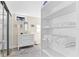 Bright bathroom with a modern vanity, mirror, open shelving, and glass enclosed shower at 2830 Gypsy St, Sarasota, FL 34231