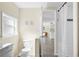 Bright bathroom leads to living area and features tile flooring, toilet, and shower at 2830 Gypsy St, Sarasota, FL 34231