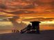 Beautiful sunset view of the beach with a lifeguard tower silhouetted against the colorful sky at 2830 Gypsy St, Sarasota, FL 34231