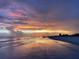 Stunning beach sunset reflecting on the wet sand, with the sky ablaze in vivid hues of orange, pink, and purple at 2830 Gypsy St, Sarasota, FL 34231