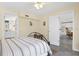 Bedroom with neutral tones, a ceiling fan, and a peek into the kitchen at 2830 Gypsy St, Sarasota, FL 34231