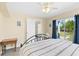Bright bedroom featuring neutral walls, ceiling fan, and sliding glass doors at 2830 Gypsy St, Sarasota, FL 34231