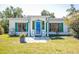 Charming home with a well-maintained lawn, vibrant green shutters, and a welcoming front entrance at 2830 Gypsy St, Sarasota, FL 34231
