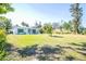 Spacious front yard featuring manicured lawn and a well-maintained exterior with mature landscaping at 2830 Gypsy St, Sarasota, FL 34231