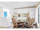 Well-lit kitchen featuring white appliances and a casual dining area at 2830 Gypsy St, Sarasota, FL 34231