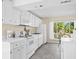 Well-lit kitchen with white cabinets, modern appliances, and a large window at 2830 Gypsy St, Sarasota, FL 34231