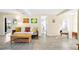 Cozy living room featuring neutral tones, tile flooring, and comfortable seating with colorful decorative pillows at 2830 Gypsy St, Sarasota, FL 34231