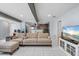 Open-concept living room featuring neutral decor, tile flooring, and wooden beams with a glimpse into the kitchen at 2910 11Th W Ave, Bradenton, FL 34205