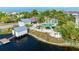 Beautiful aerial shot of waterfront community with pool, boat dock, lush landscaping, and a serene coastal atmosphere at 315 Sapphire Lake Dr # 202, Bradenton, FL 34209
