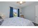 Light-filled bedroom with a window view, chair and neutral paint at 315 Sapphire Lake Dr # 202, Bradenton, FL 34209