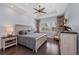 Serene bedroom featuring light blue walls, wood floors, and natural light at 315 Sapphire Lake Dr # 202, Bradenton, FL 34209