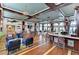 A stylish clubhouse interior with a bar, casual seating, and nautical-themed decor at 315 Sapphire Lake Dr # 202, Bradenton, FL 34209