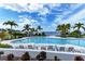 Relax by the community pool with inviting lounge chairs, lush landscaping, and serene waterfront views at 315 Sapphire Lake Dr # 202, Bradenton, FL 34209