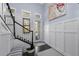 Elegant foyer featuring hardwood floors, custom wainscoting, and a staircase with a black banister at 315 Sapphire Lake Dr # 202, Bradenton, FL 34209