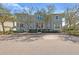 Charming two-story home with a well-manicured lawn, inviting front porch, and mature trees at 315 Sapphire Lake Dr # 202, Bradenton, FL 34209