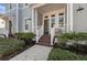 Inviting front porch with decorative railing, a bench, and well-maintained landscaping at 315 Sapphire Lake Dr # 202, Bradenton, FL 34209