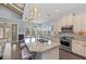 Open kitchen features island with seating, stainless steel appliances, and a connected dining area at 315 Sapphire Lake Dr # 202, Bradenton, FL 34209