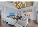Cozy living room features hardwood floors, TV, comfortable seating, and bright, airy space at 315 Sapphire Lake Dr # 202, Bradenton, FL 34209