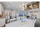 Open concept living space with kitchen, dining, and living room with a neutral color scheme and wood floors at 315 Sapphire Lake Dr # 202, Bradenton, FL 34209